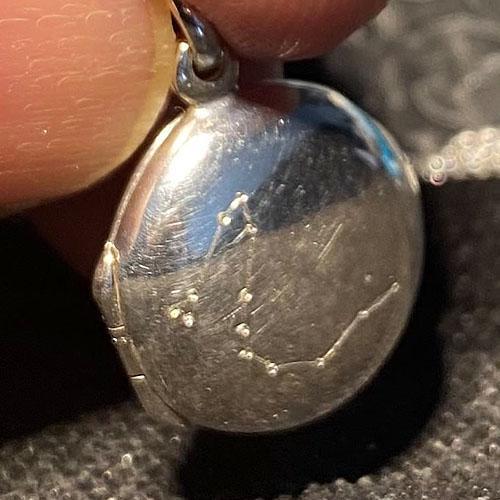 Silver locket with a star constellation of particular significance to its recipient
