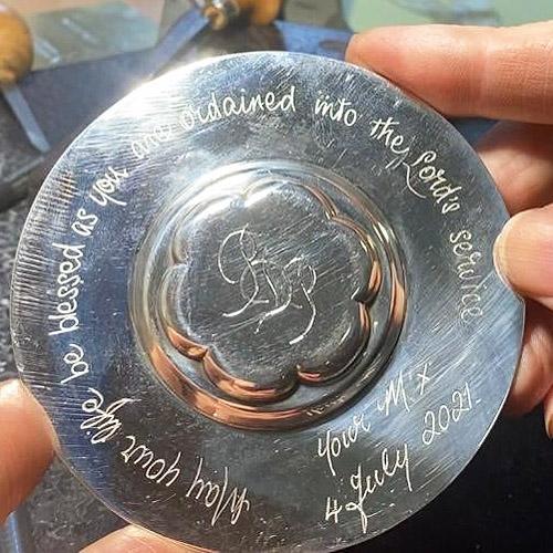 Hand engraved personal inscription on the reverse of a small silver dish