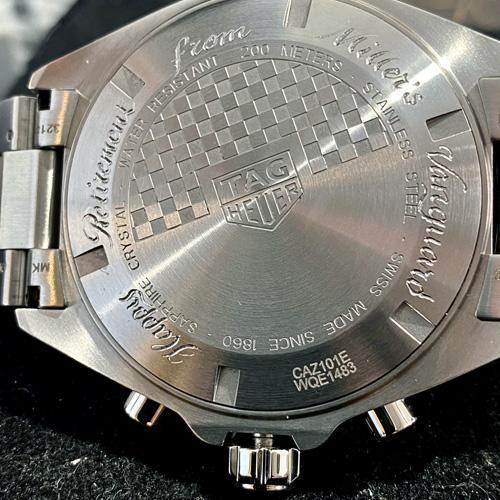 TAG Heur watch with a hand engraved inscription in a script font on its rear casing