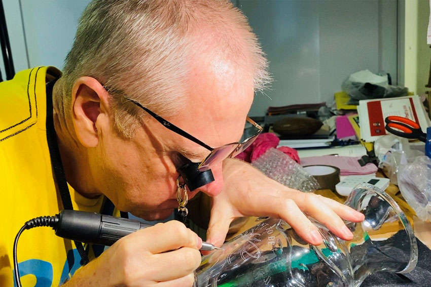 Hand engraving a crystal vase