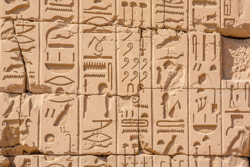 Hieroglyphs on walls of Hypostyle Hall in Karnak Temple located in ancient Thebes, Egypt.